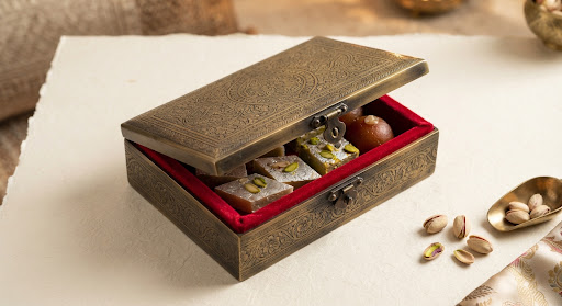 Heritage Brass Box: floral-engraved brass sweet box open to show a red velvet interior
