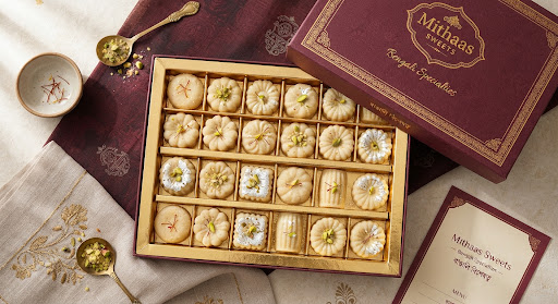 Sondesh Artisanal Box: pale chhena fudge pieces with saffron and pistachio in a gold-lined box